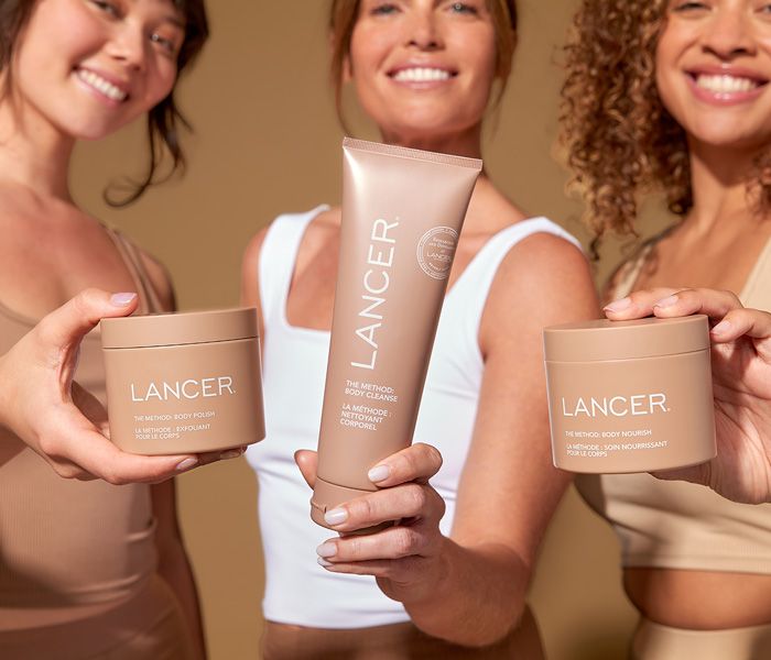 Three women holding Lancer Skincare products